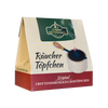 Eine Kartonpackung „Räuchertöpfchen“ von Original Crottendorfer Räucherkerzen zeigt die Abbildung eines Räuchergefäßes mit Holzgriff und Metallsieb sowie einen deutschen Text, der die Essenz des traditionellen Weihrauchs zusammenfasst.