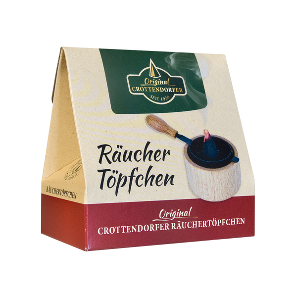 Eine Kartonpackung „Räuchertöpfchen“ von Original Crottendorfer Räucherkerzen zeigt die Abbildung eines Räuchergefäßes mit Holzgriff und Metallsieb sowie einen deutschen Text, der die Essenz des traditionellen Weihrauchs zusammenfasst.