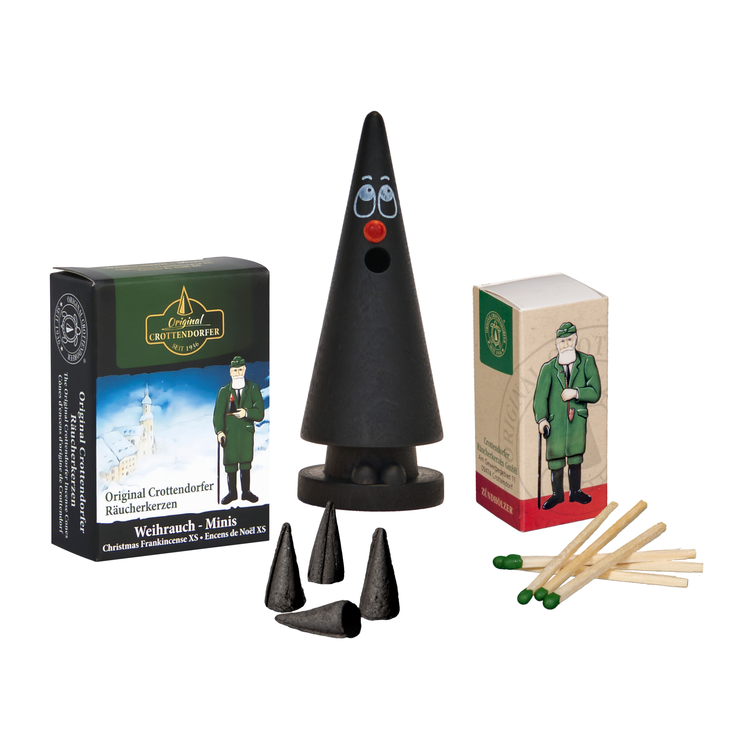 Das Mini-Räucherset „Der kleine Willy“ von Original Crottendorfer Räucherkerzen enthält eine bezaubernde Zwergen- oder Weihnachtswichtelfigur, kegelförmige Räucherkegel und zwei Streichholzschachteln mit der Aufschrift „Crottendorfer Streichhölzer“ und abgebildeten Figuren, von denen eine einem Soldaten ähnelt. Der Verpackungstext ist in deutscher Sprache.