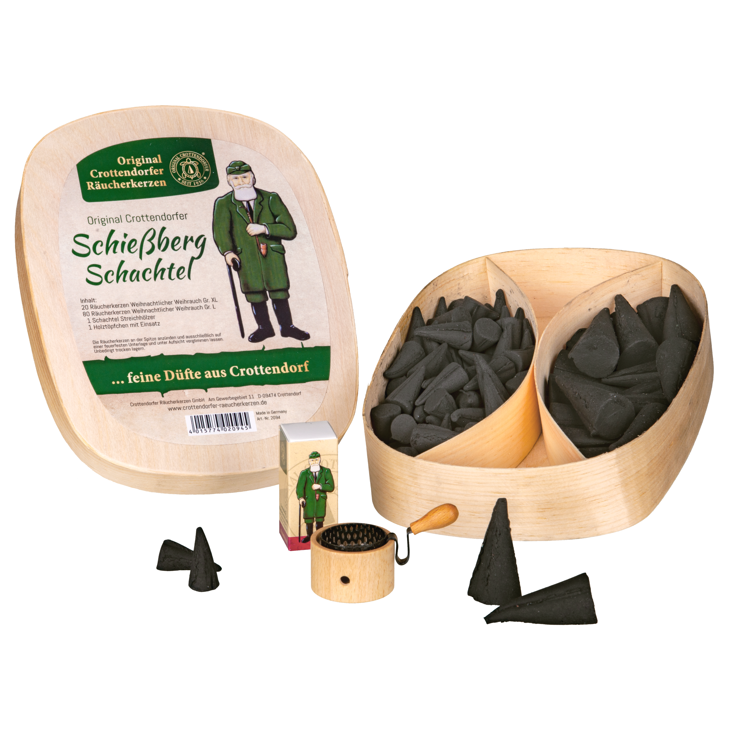 Das Geschenkset 'Schießberg'-Schachtel von Original Crottendorfer Räucherkerzen enthält eine Holzbox, kleine schwarze Weihrauchkegel, eine Mini-Räucherfigur aus Holz und eine kleine runde Reibe, wobei einige Kegel außerhalb der Box ausgestellt sind.
