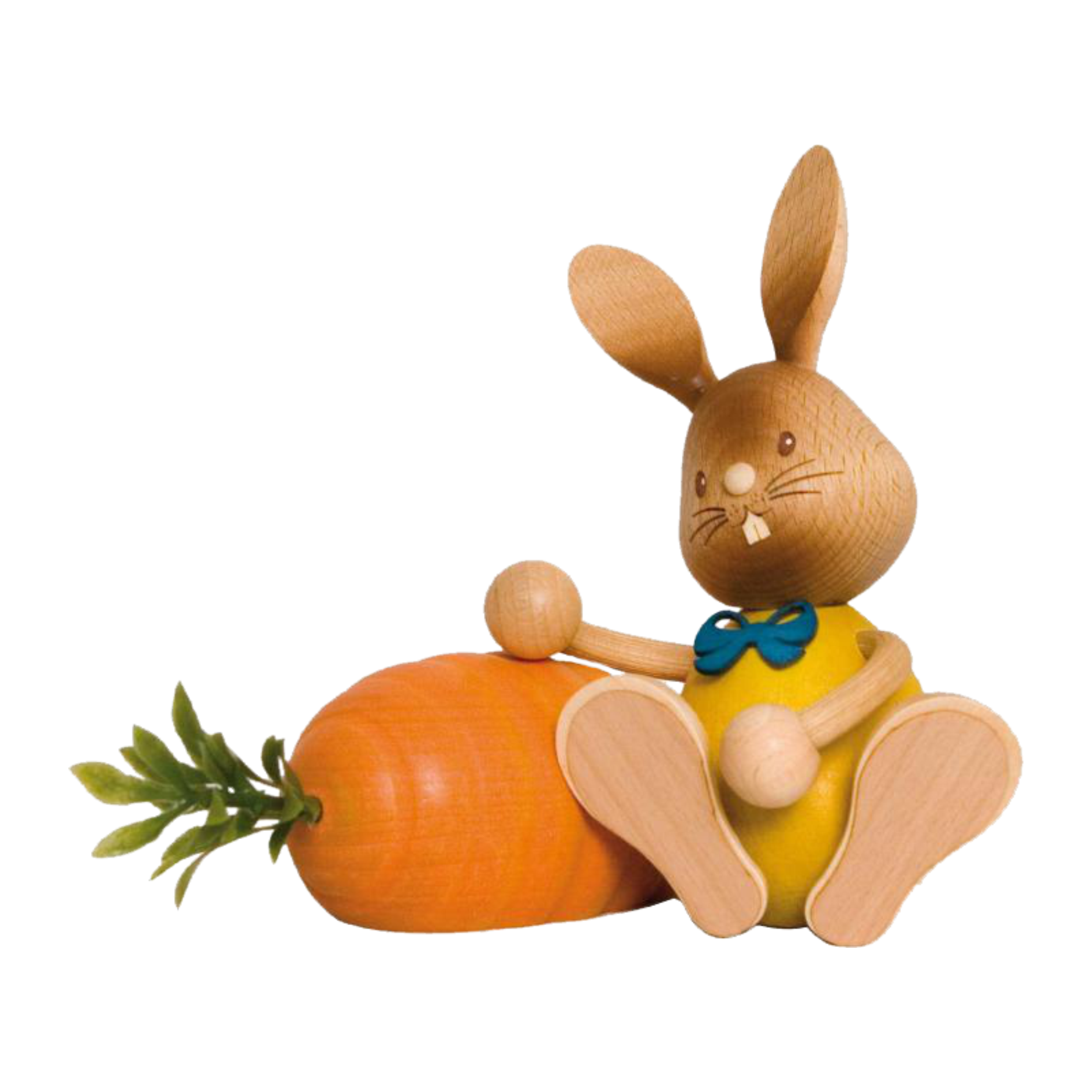 Der Stupsi Hase mit Möhre von Drechslerei Kuhnert ist eine hölzerne Hasenfigur in Gelb mit blauer Schleife, die neben einer übergroßen orangefarbenen Karotte mit üppigen grünen Blättern sitzt und aufwendige handgeschnitzte Details und einen fröhlichen Gesichtsausdruck aufweist.