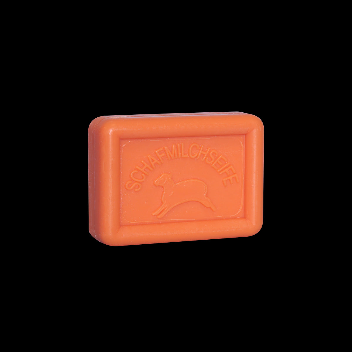 Auf schwarzem Untergrund ist eine rechteckige orangefarbene Tafel Ovis Schafmilchseife Blutorange mit der Prägung „SCHAFMILCHSEIFE“ und einer Schafskontur abgebildet.