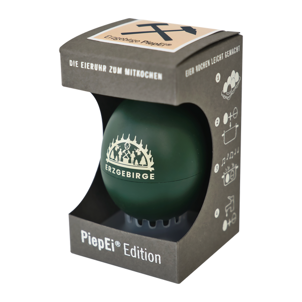 Das PiepEi „Erzgebirge“ von BrainStream ist ein grüner, eiförmiger Küchenwecker in einer dunkelgrauen Box mit verspielten Illustrationen von Eiern, Töpfen und Musiknoten. Er ist ideal für perfekt gekochte Eier und wird mit einer deutschen Anleitung geliefert.