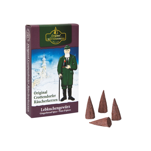 Eine Schachtel mit Original Crottendorfer Räucherkerzen „Lebkuchengewürz“, die den einladenden Duft klassischer Lebkuchengewürze verströmen; neben der Verpackung sind vier braune Räucherkegel abgebildet. Die Schachtel ist mit der Abbildung eines Mannes in grünem Mantel und Hut verziert, der den warmen Weihnachtsduft von traditionellem Zimt und festlichen Leckereien verkörpert.