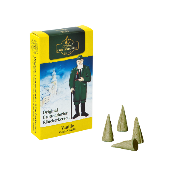Eine gelb-schwarze Schachtel mit der Aufschrift „Original Crottendorfer Räucherkerzen“ zeigt einen Mann in traditioneller Kleidung, der neben sich vier kleine kegelförmige Räucherkegel hält. Der Duft „Räucherkerzen Vanille“ verleiht dieser reizvollen Komposition ein süßes Vanillearoma.