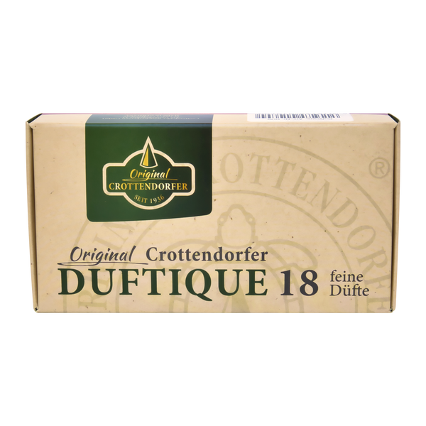 Die beigefarbene Dose der Original Crottendorfer Räucherkerzen Duftique 18 feine Düfte - Weihnachtsdüfte & Editionen ist mit einem grün-goldenen Etikett versehen, das klassische Weihnachtsdüfte und einen wohltuenden Sandelholzduft enthält.