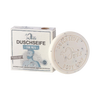 Ein runder Riegel Ovis Duschseife für Männer mit Sheabutter liegt neben der Schachtel, die einen bärtigen Mann beim Duschen zeigt und Text in Deutsch, Französisch, Italienisch und Englisch enthält.