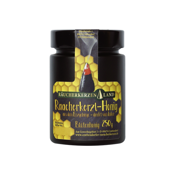 Ein 250 g schweres schwarzes Glas „Raacherkerzl-Honig“ von Original Crottendorfer, versehen mit einem Etikett mit Wabenmuster und einer Räucherkegel-Abbildung, handgefertigt vom örtlichen Imker und bezogen aus der ruhigen Erzgebirge-Region.