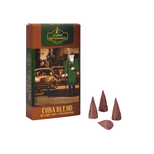 Die Schachtel „Räucherkerzen Cuba Blend“ mit einem Oldtimer und einer Figur im grünen Anzug enthält drei aufrecht stehende braune Räucherkegel und zwei liegende, die den Duft kubanischer Zigarre hervorrufen. Die Verpackung ist mit dem Markennamen „Original Crottendorfer Räucherkerzen“ versehen.
