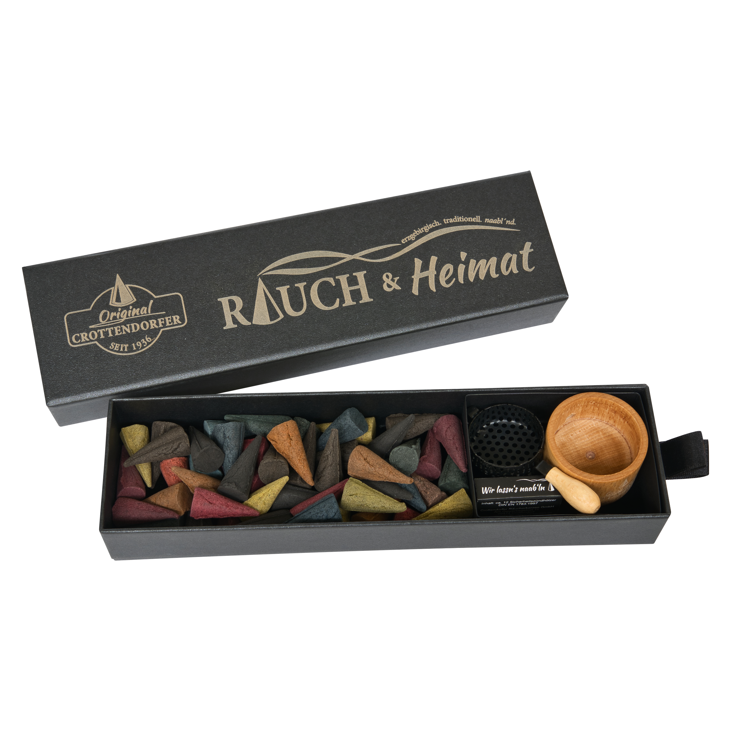 Eine Schubbox „RAUCH & Heimat“ von Original Crottendorfer Räucherkerzen enthält bunte Räucherkegel, eine kleine Holzschale und einen Metallhalter – stilvolle Räucheraccessoires –, die ordentlich in der offenen schwarzen Schachtel angeordnet sind und sie so zum perfekten Geschenk machen.