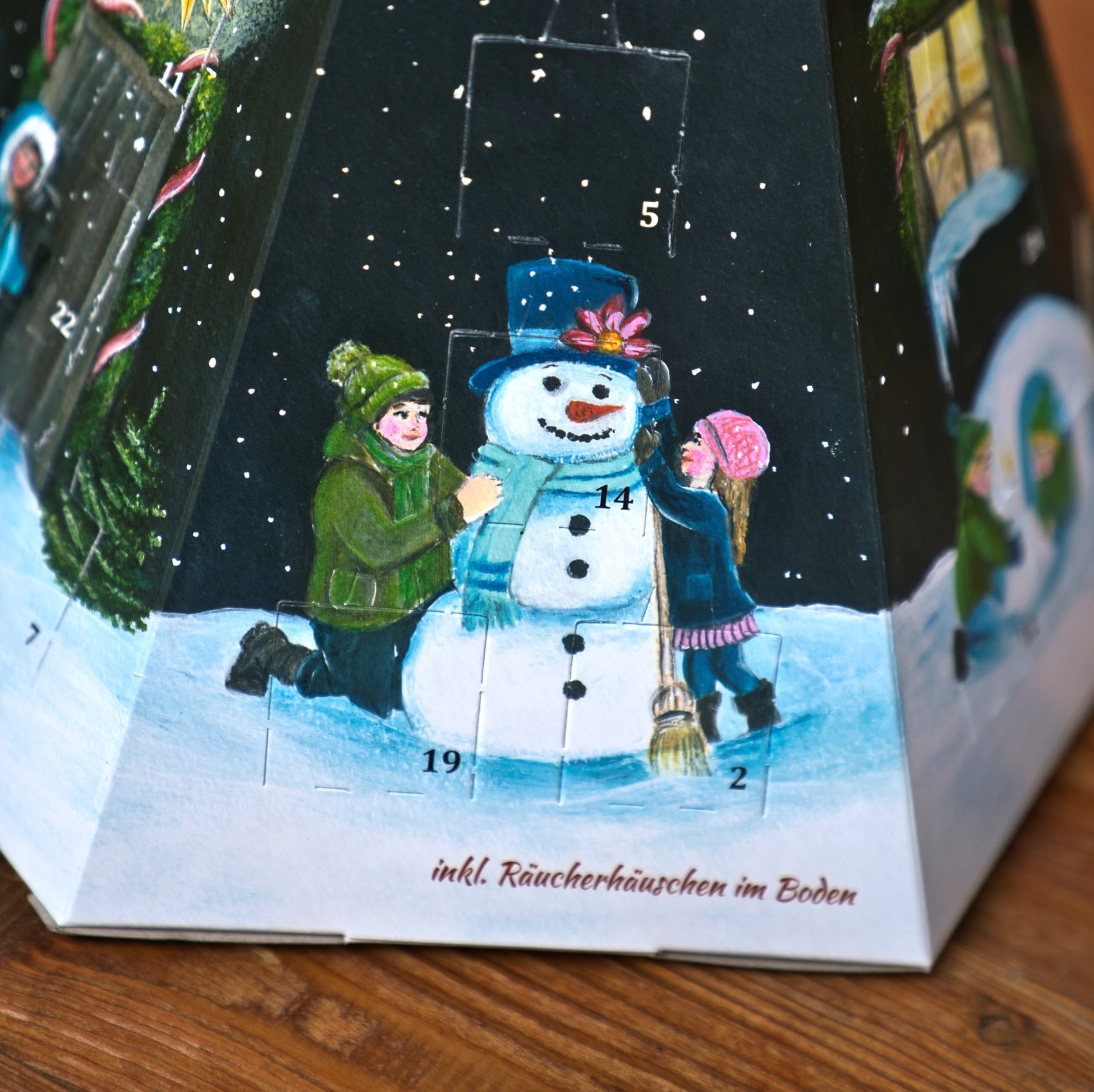 Pyramidenförmiger Räucherkerzen-Adventskalender – Pyramide mit einem gemalten Wintermotiv, auf dem Kinder einen Schneemann bauen, mit 24 verschiedenen Räucherduftnoten.