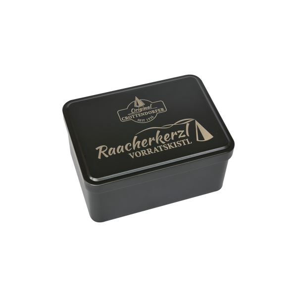 Vor einem schlichten weißen Hintergrund ist eine schwarze, rechteckige Aufbewahrungsbox von Original Crottendorfer zu sehen, die mit der Aufschrift „Raacherkerzl Vorratskistl“ versehen ist und mit einfachen Motiven eines Hauses und eines Räucherkegels verziert ist.