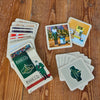 Spiel Finde2 Motiv Sortimentsauszug Faltschachtel und Karten arrangiert auf dunklem Holz