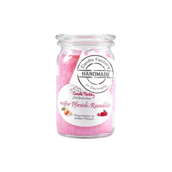 Die Candle Factory Duftkerze/Windlicht "weißer Pfirsich - Rosenblüte" Baby-Jumbo ist eine Weckglas-Glaskerze mit rosa Wachs und der Aufschrift "Handmade in Germany". Sie duftet nach weißer Pfirsich-Rose und zeigt blumig-fruchtige Motive.