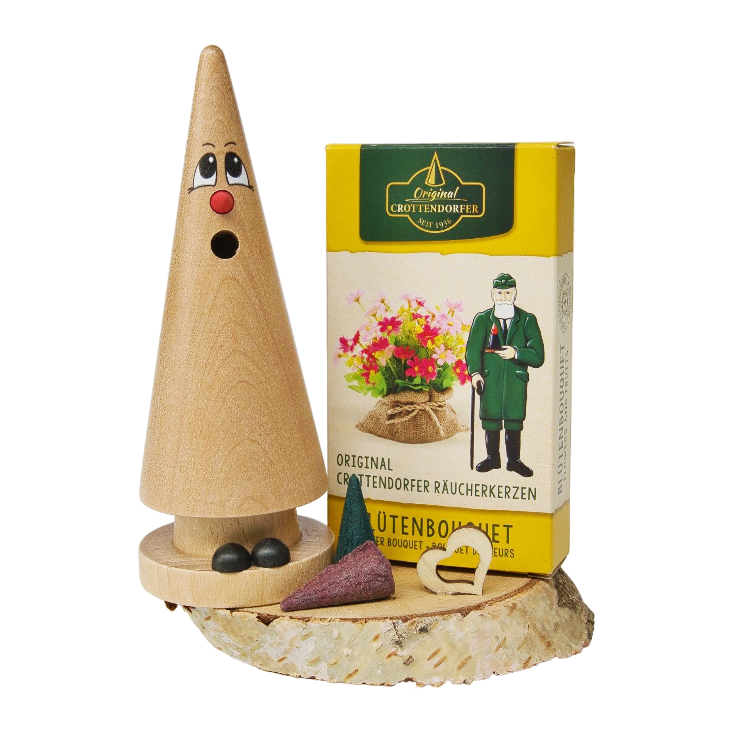 Das Geschenkset „Ziegenbein + Räucherkerzen“ von Original Crottendorfer Räucherkerzen besteht aus einem hölzernen Räuchergefäß mit einem Gesicht auf einem Holzsockel sowie einer gelben Schachtel mit Räucherkegeln – auf weißem Hintergrund präsentiert, eignet es sich perfekt als Ostergeschenkset.