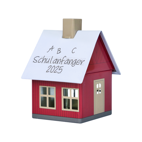 Das Original Crottendorfer Räucherhäuschen Schulanfänger 2025 ist ein charmantes kleines rotes Modell mit Kamin, weißem Dach, mehreren Fenstern, einladender Tür und der handschriftlichen Aufschrift „ABC Schulanfänger 2025“.