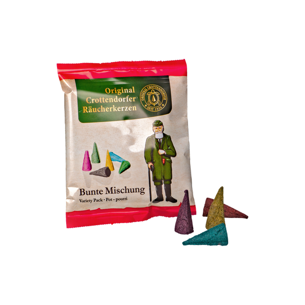 Die „Räucherkerzen Probierpackung Bunte Mischung“ von Original Crottendorfer Räucherkerzen präsentiert sich in einer rot-weißen Verpackung mit traditioneller Illustration. Vorne sind drei bunte Zapfen zu sehen, hervorgehoben als „Bunte Mischung Variety Pack – Potpourri“.