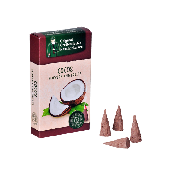 Eine Schachtel „Räucherkerzen Cocos“ von Original Crottendorfer Räucherkerzen zeigt das Bild einer halbierten Kokosnuss. Drei braune Räucherkegel liegen neben der burgunderfarbenen Verpackung, akzentuiert mit Grün und Weiß.